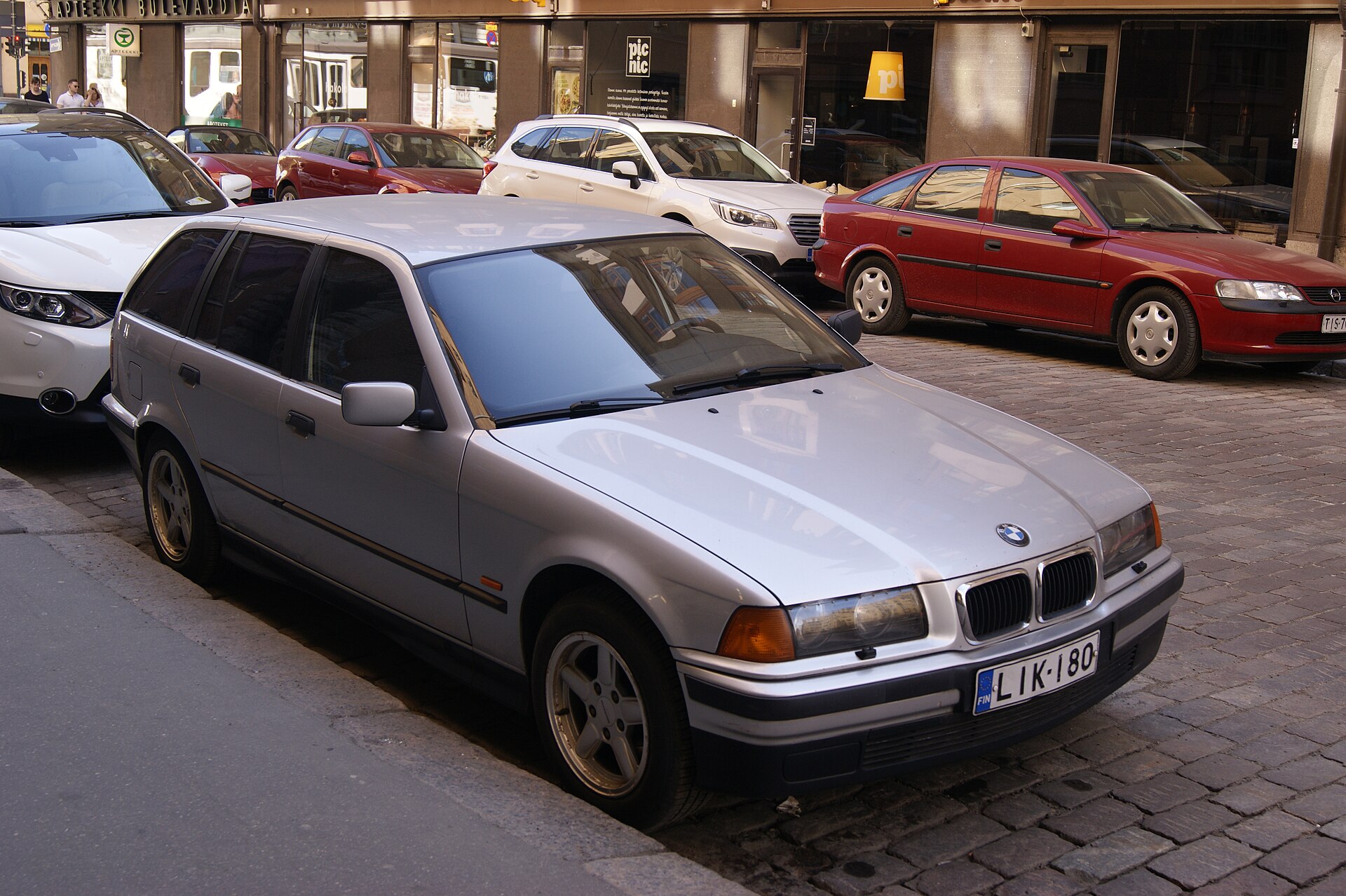 Silver BMW 316i E36 Touring photographed from the front three-quarter view