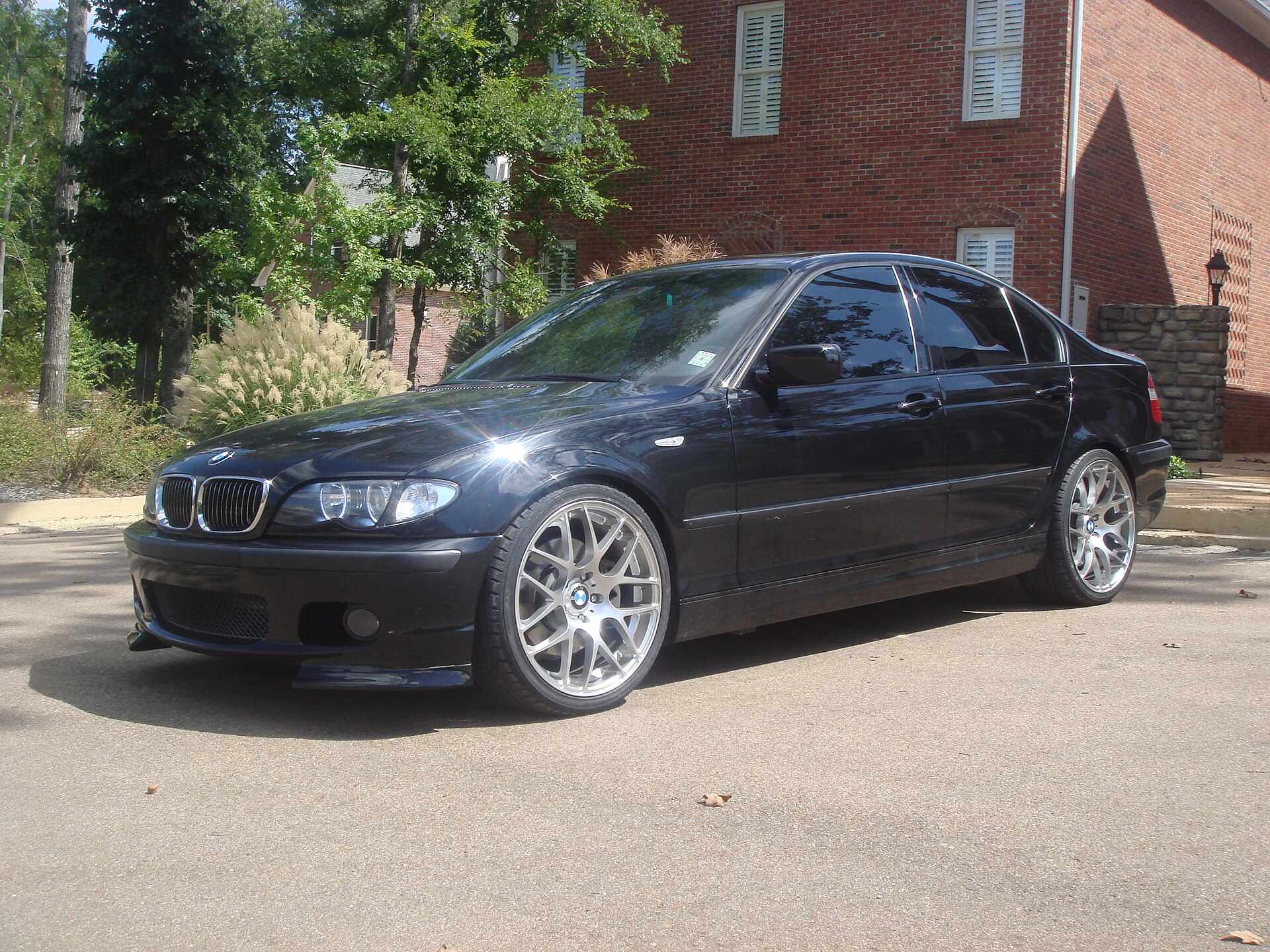 Black BMW 330i ZHP E46 sedan photographed from the front three-quarter view