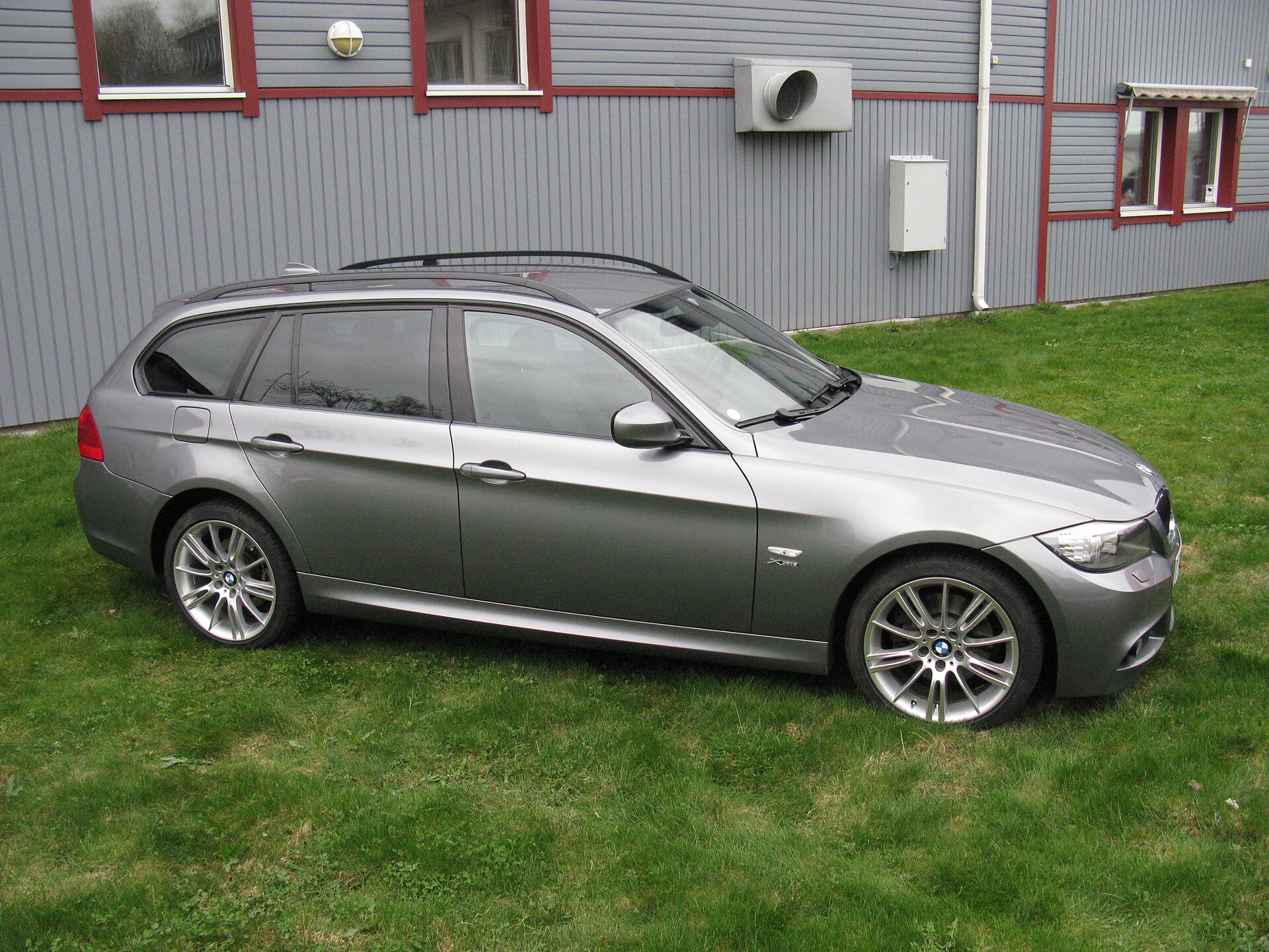 Silver BMW E91 Touring photographed from an elevated front three-quarter view