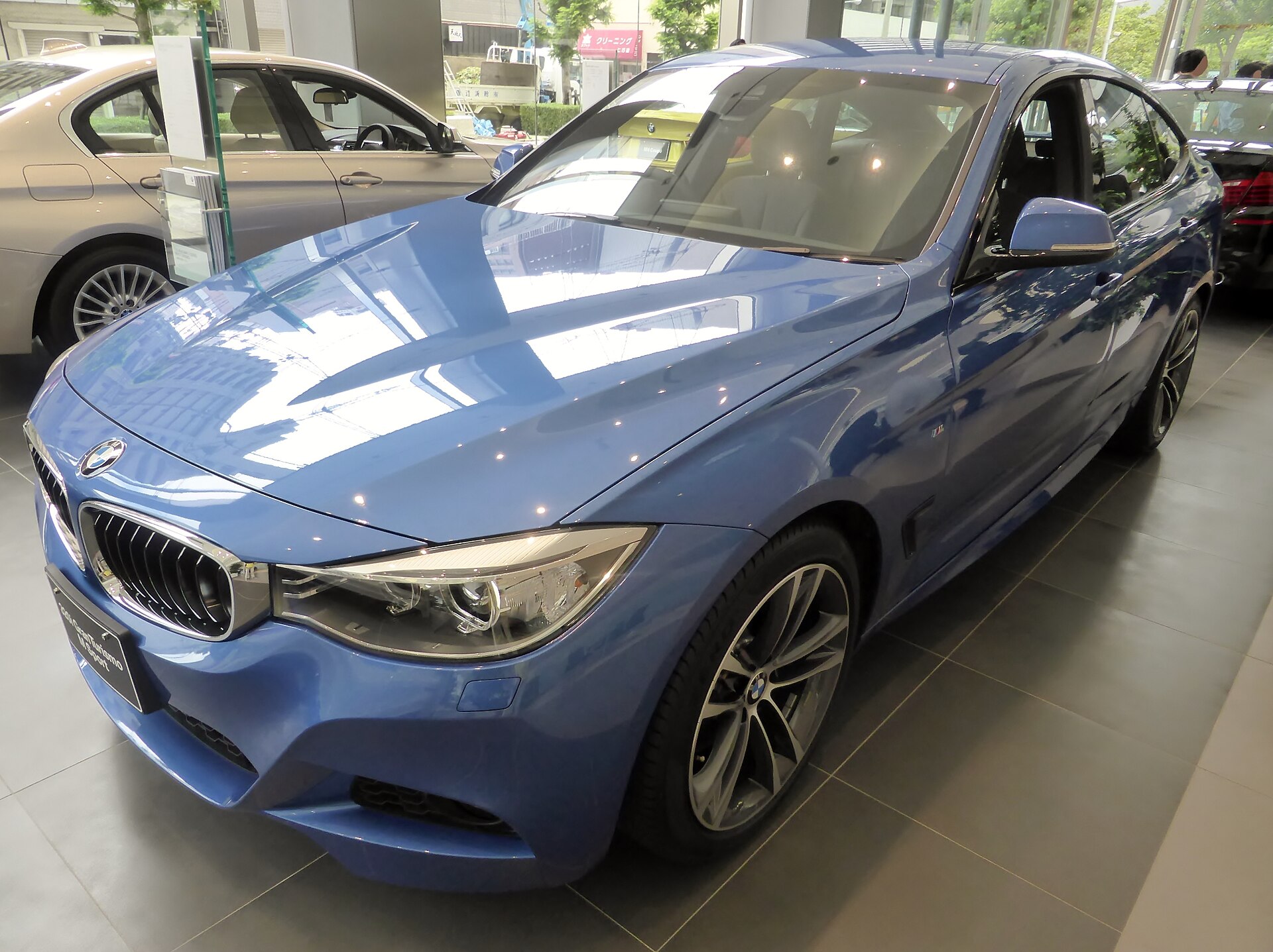 Blue BMW F34 Gran Turismo photographed from the front three-quarter view
