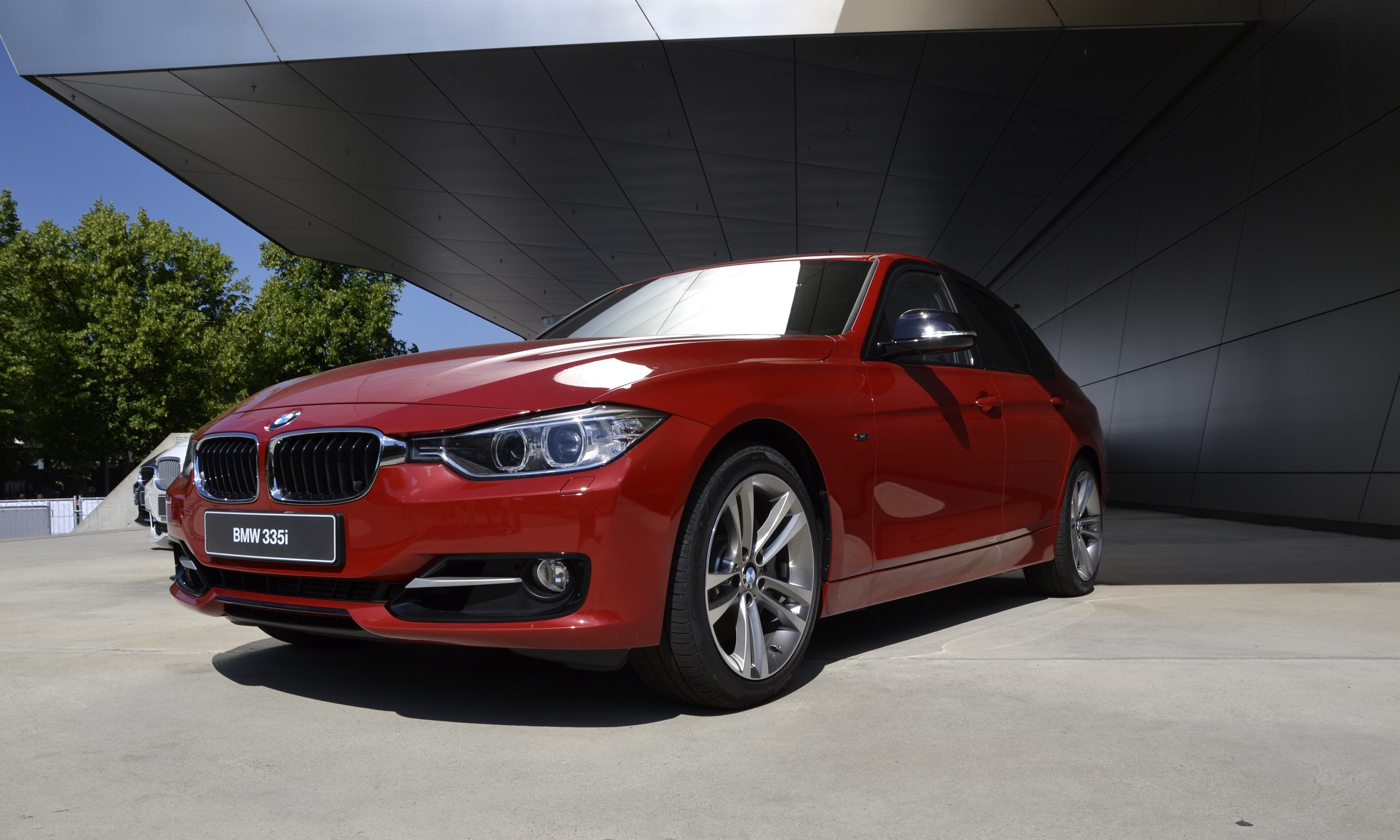 Red BMW 335i F30 sedan photographed outside BMW Welt in Munich